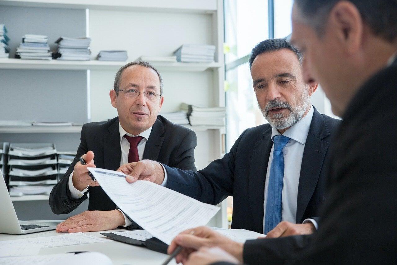 Executive leaders in business meeting aligning organizational vision, leadership strategy, and team performance through fractional leadership alignment services.