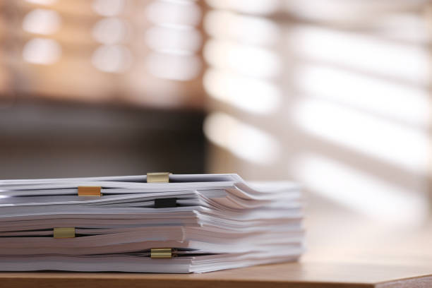 Stack of business contracts and legal documents representing efficient contract management, compliance oversight, and risk reduction through fractional contract management services.